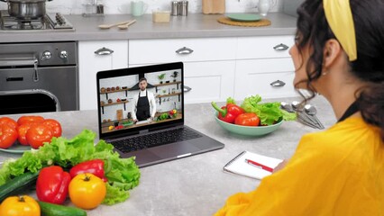 Woman in home kitchen greets study online video call webcam laptop listen teacher. Man chef food blogger in computer screen tells recipe of dish teaches housewife remote cooking culinary lesson course