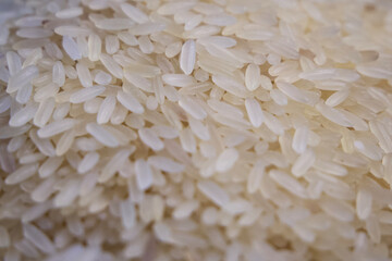 Rice grains, close-up shot. A scattering of rice as a background.
