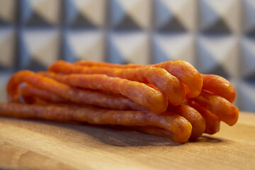 Polish smoked cabanossi sausages on a wooden surface.