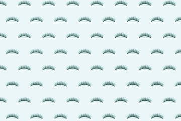 Pave eyelashes on blue background. Female cosmetics. Extension and lengthening of eyelashes. Pattern.