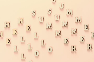 Text of wooden letters Hello summer on yellow background. Summer time concept. New season. Summer greeting. Pattern.