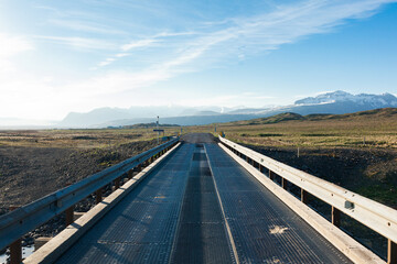 Road  bridge in Iceland. Snow in mountains in background. 