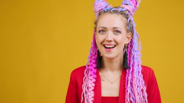 Young stylish woman in red costume thinking comical, looking for idea, creativity. Creative person thinks something suspicious, tricky and cunning. Hairs with dreadlocks afro braids locks.