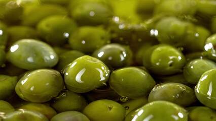 Close-up of green olives placed in oil.