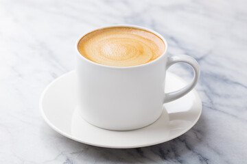 Coffee, espresso in white cup. Marble background. Close up.