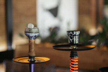 Hookah smoking at a party concept. Hookah stands on a wooden table in a restaurant. Smoking...
