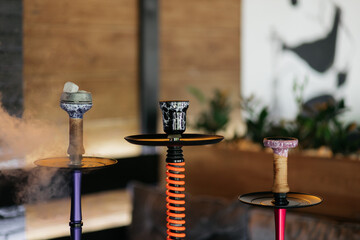 Hookah smoking at a party concept. Hookah stands on a wooden table in a restaurant. Smoking concept. Hookah on the table. Smoking tobacco.