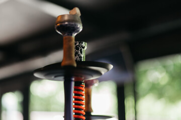 Hookah smoking at a party concept. Hookah stands on a wooden table in a restaurant. Smoking...