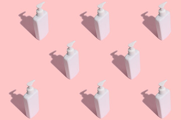 Pattern. White tube of cosmetic cream with a hard black shadow on a pink background.