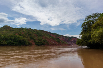 Calm sunset on the Huallaga River under a blue sky in the Peruvian jungle.