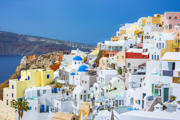 Oia town on Santorini island, Greece. Traditional and famous houses and churches with blue domes over the Caldera, Aegean sea