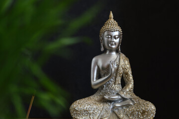Buddha statuette on a dark background
