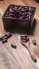 Red kidney beans on wooden spoon