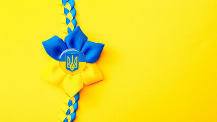 Ukrainian flower trident symbol isolated on yellow. Yellow blue banner background, flat lay, copy...