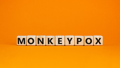 Monkeypox virus pandemic symbol. Concept words Monkeypox on wooden blocks. Beautiful orange table orange background. Medical and Monkeypox virus pandemic concept. Copy space.