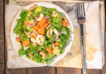 Healthy food vegetable broccoli salad in bowl on wood background.