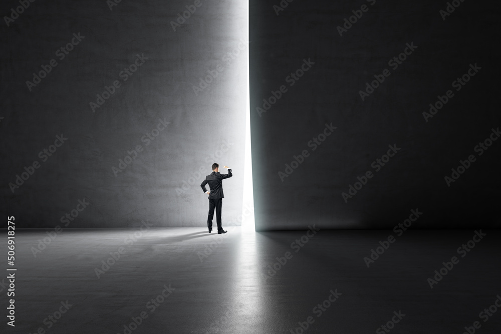 Poster business success and look into the future concept with businessman looking through a light hole in a