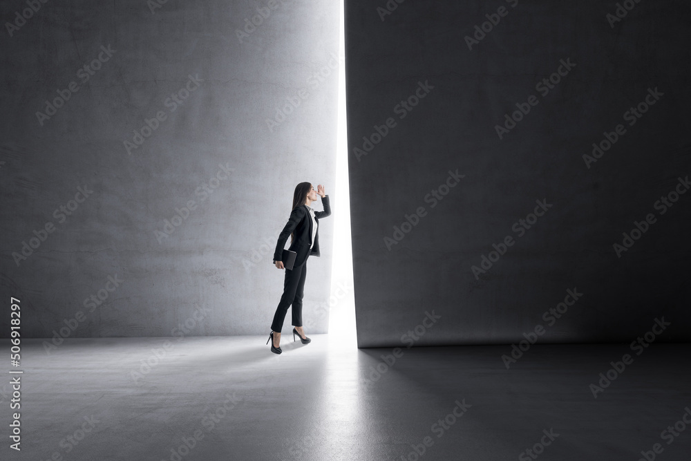 Aufkleber look into the future and business success concept with businesswoman looking through a light hole in