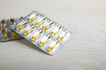 Packaging of Omega 3 capsules on a white textural background. Fish oil, tablets, capsules and...