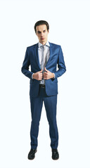 Young self-confident man in blue suit and grey tie on white wall background