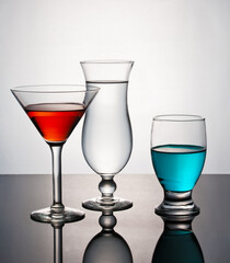 Conceptual presentation of glassware with colorful liquid.