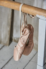 Pink Ballet shoes at bar in ballet class .