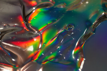 Abstract cosmetics gel on holographic background.Good as cosmetic banner,selective focus.