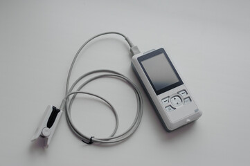Pulse oximeter on a white background. Medical control and diagnostic device for measuring the saturation of capillary blood with oxygen
