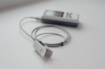 Fototapeta premium Pulse oximeter on a white background. Medical control and diagnostic device for measuring the saturation of capillary blood with oxygen