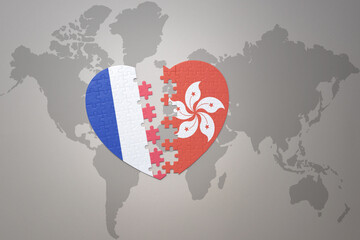 puzzle heart with the national flag of france and hong kong on a world map background. Concept.