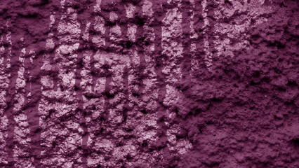 Rough relief wall of purple plaster.