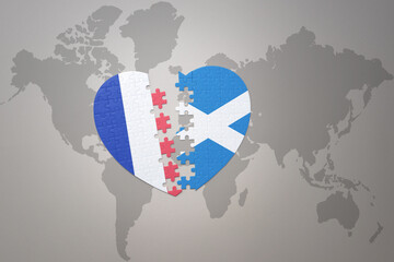 puzzle heart with the national flag of france and scotland on a world map background. Concept.