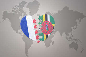 puzzle heart with the national flag of france and dominica on a world map background. Concept.