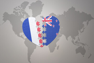 puzzle heart with the national flag of france and new zealand on a world map background. Concept.