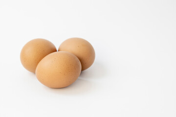 Three chicken eggs isolate on white background.