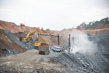 A large quarry dump truck in a coal mine. Loading coal into body work truck. Mining equipment for the transportation of minerals.