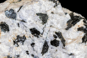 Pegmatite granite from central Arizona. Large black biotite mica crystals against white quartz....