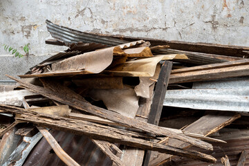 Waste of demolishing material building, heap of timber, wood, and wave rust zinc panel.  