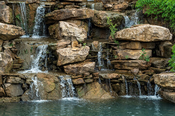 landscape design, a dam with a cascade of waterfalls in the form of natural rocks
