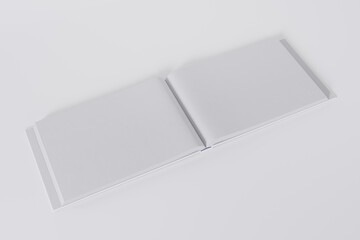 Mockup of a rectangular open book with a blank, glossy, white cover on white background. Isolated with clipping path.	