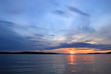 Gorgeous sunset at golden hour. Swedish nature or lake during spring. Relaxing vacation feeling. At Mälaren, Stockholm, Sweden, Scandinavia, Europe.
