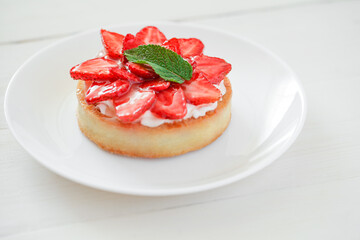 Strawberry tart, cake, on white wooden board background, selective focus.