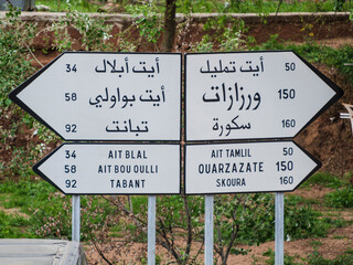 Informative traffic sign written in Latin and Arabic alphabet, Imi N'Ifri natural bridge, Demnate, Atlas mountain range, morocco, africa - obrazy, fototapety, plakaty