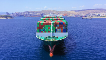Aerial drone photo of huge container ship leaving logistics and container terminal of Perama,...