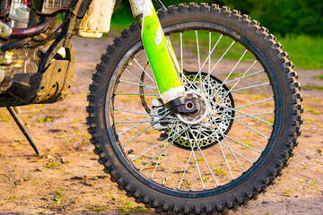 the front wheel of an extreme cross enduro motorcycle at sunset. off-road