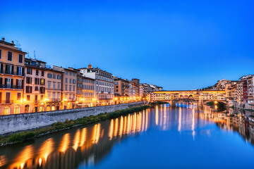 Fototapeta na wymiar Illuminated Ponte Vecchio Bridge with Reflection in Arno River at Dusk, Florence