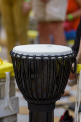 Fototapeta na wymiar White bongo drum with black fabric wrap. Yoga Festival.