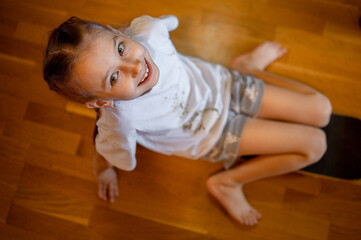 a girl rides a skateboard around the house