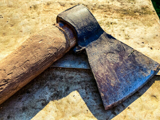the ax lies on a metal bench. a tool for cutting wood, building a house, working with wood. metal...