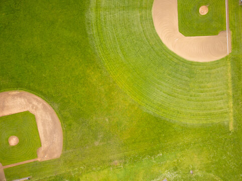 Top view of the green field for sports games. Sports, training, championships. Professional and amateur sports. Healthy lifestyle. There are no people in the photo. Minimalism. Abstraction.